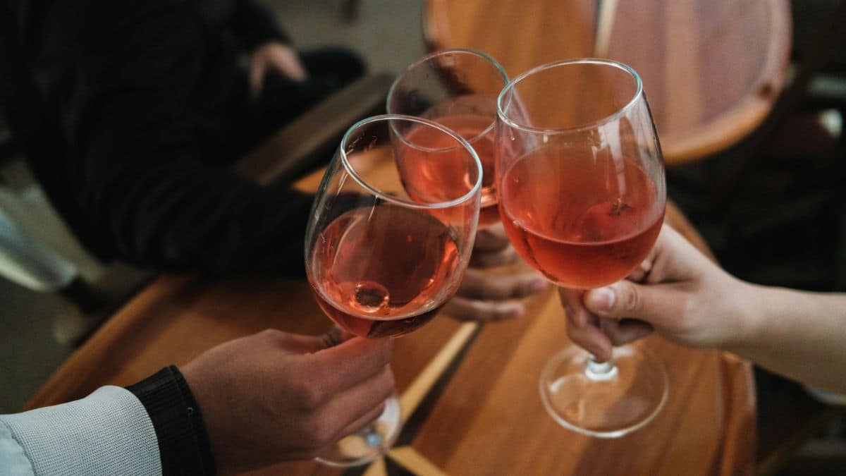 People clinking wine glasses